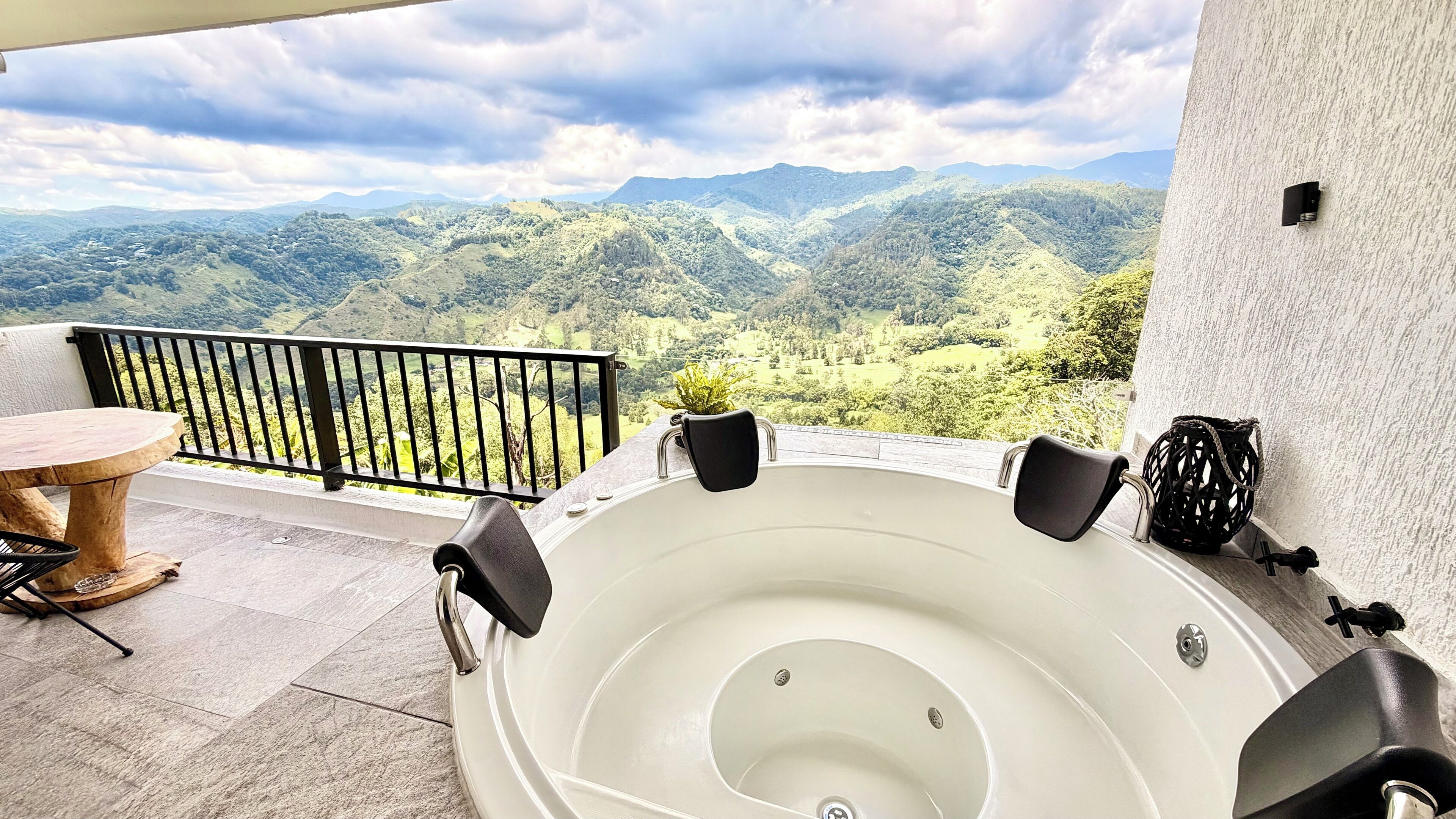 A hot tub on a balcony with a mountain view.