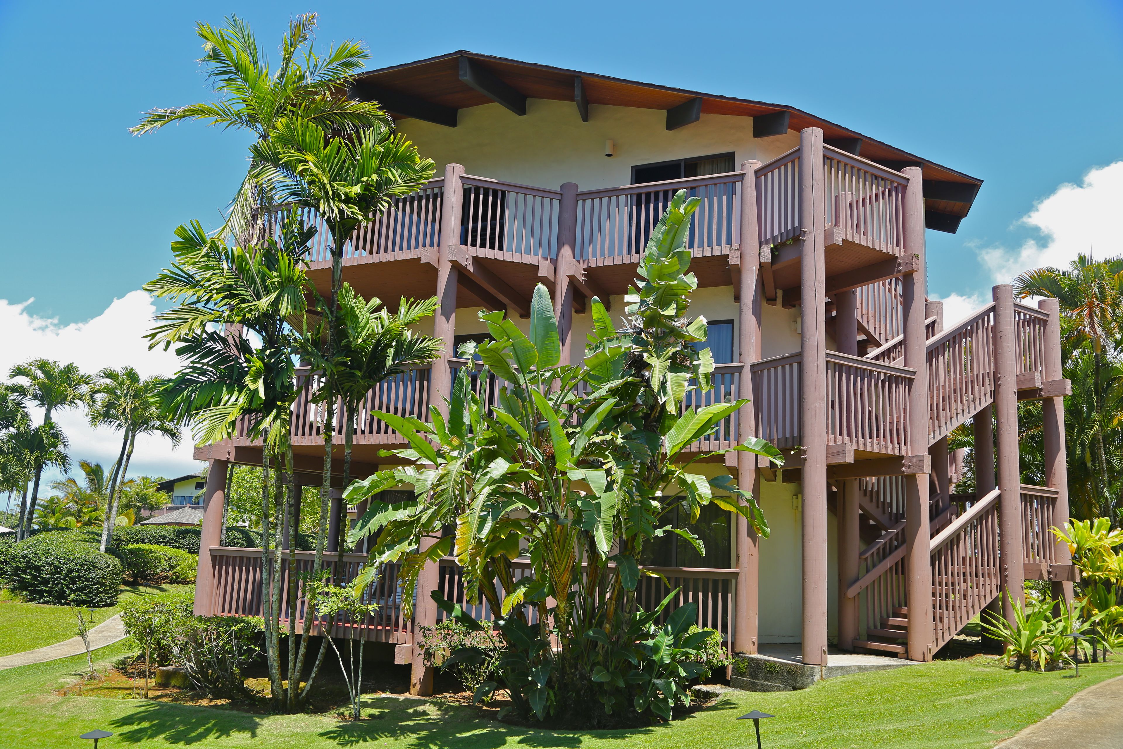 A multi-story building with balconies and a central staircase.