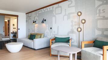 A modern living room with a sofa, armchair, and round coffee table.
