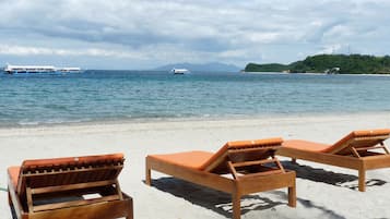 On the beach, sun-loungers, beach towels, scuba diving