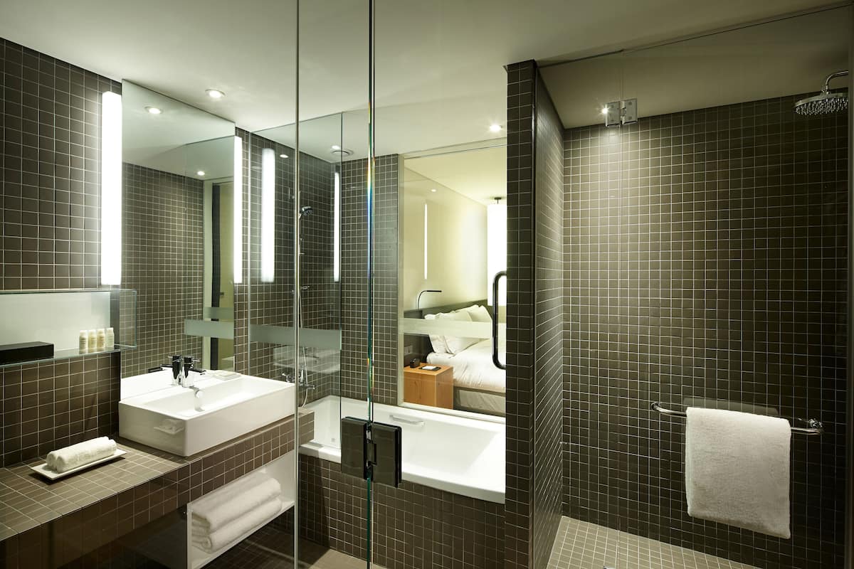 Combined shower/bathtub, deep-soaking bathtub, designer toiletries