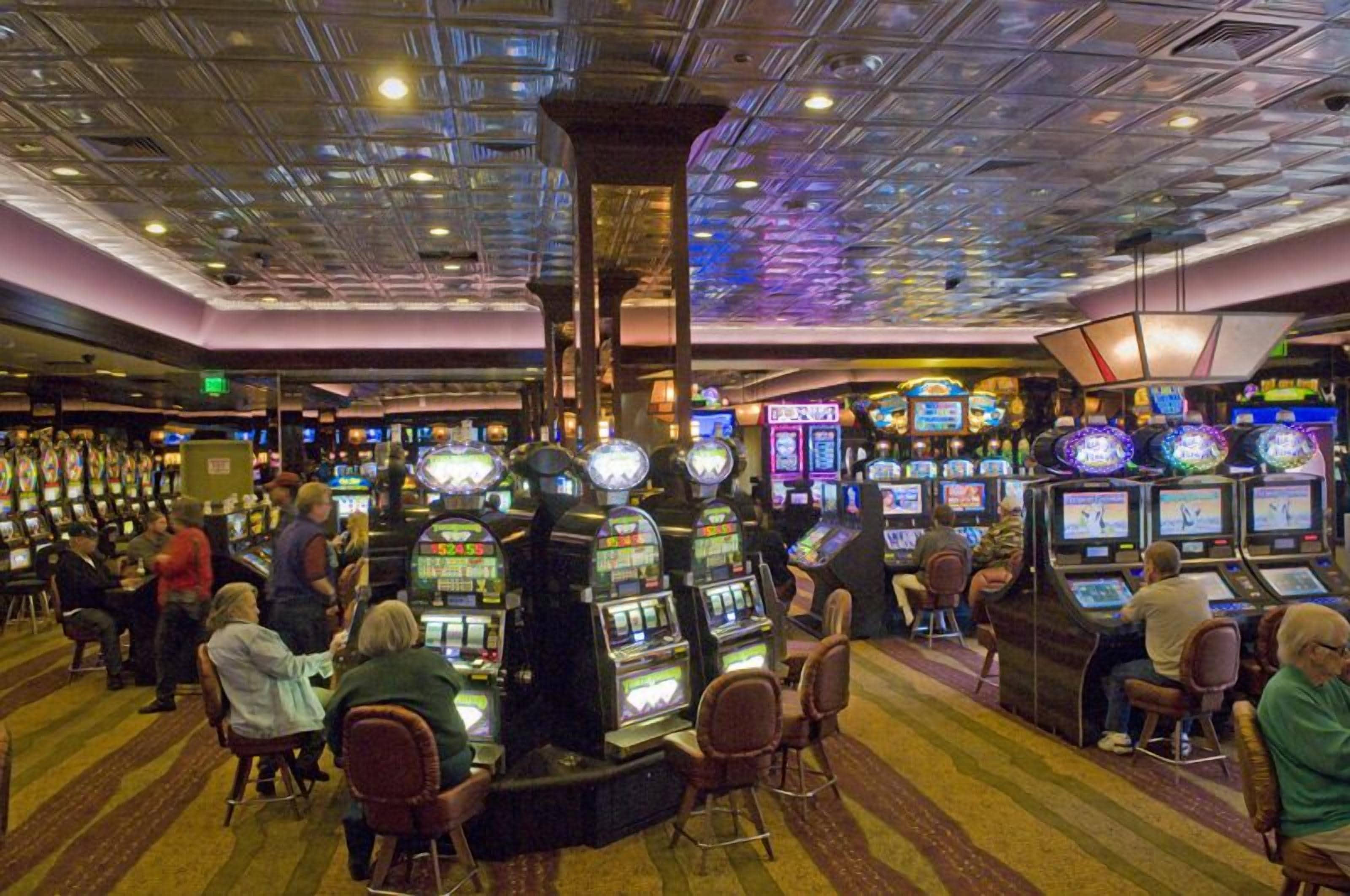 A casino with multiple slot machines and gaming tables.