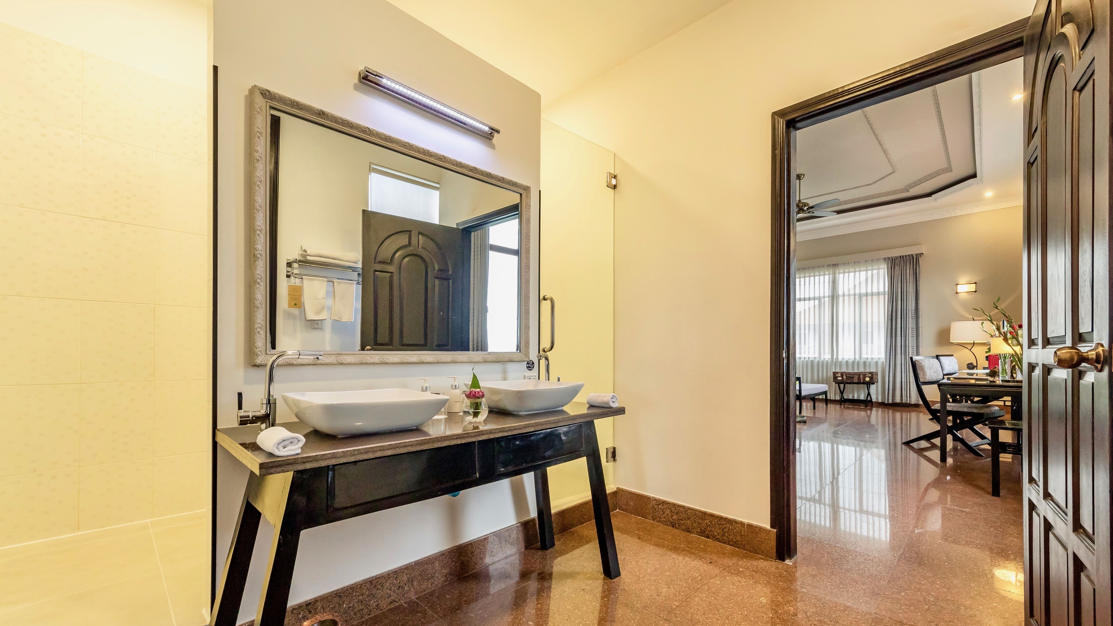 A bathroom with two sinks, a large mirror, and a vanity.