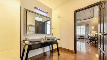 A bathroom with two sinks, a large mirror, and a vanity.