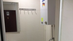 A small bathroom with a toilet, sink, and a towel rack. - China Guest Hostel (Kowloon)