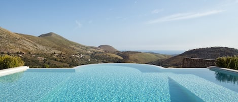 Seasonal outdoor pool, an infinity pool, pool loungers