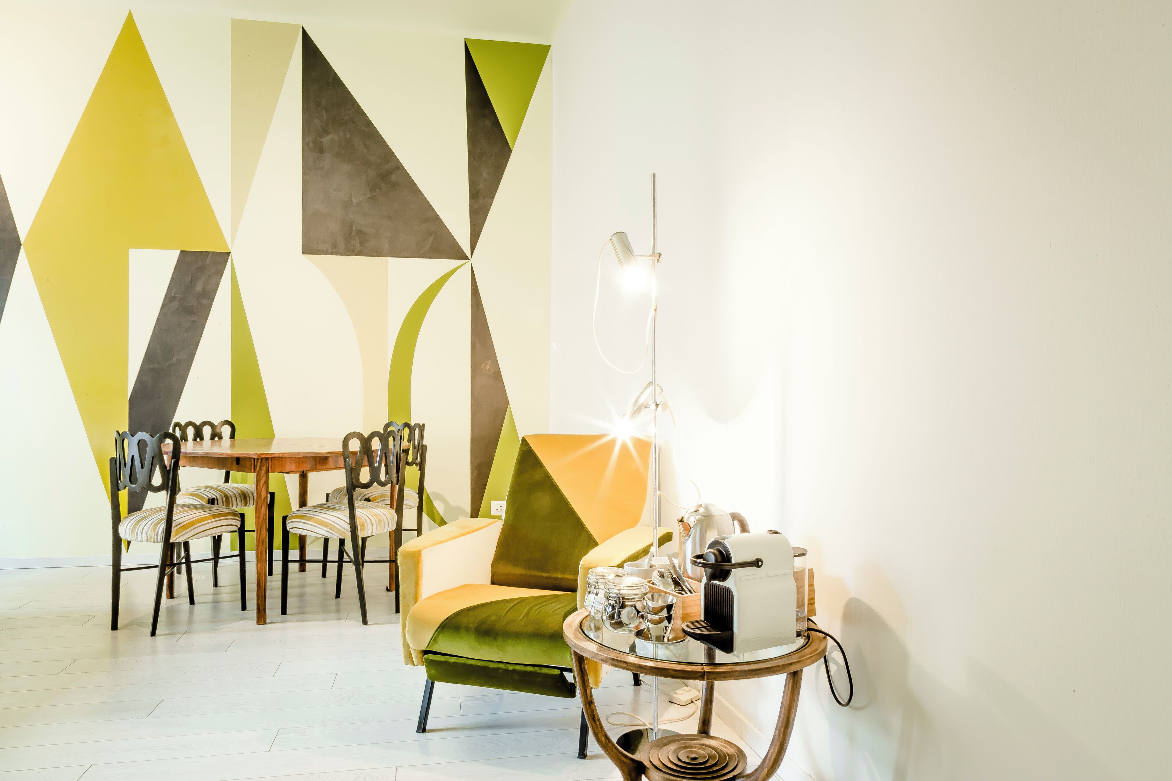A dining area with a table, chairs, and a lamp.