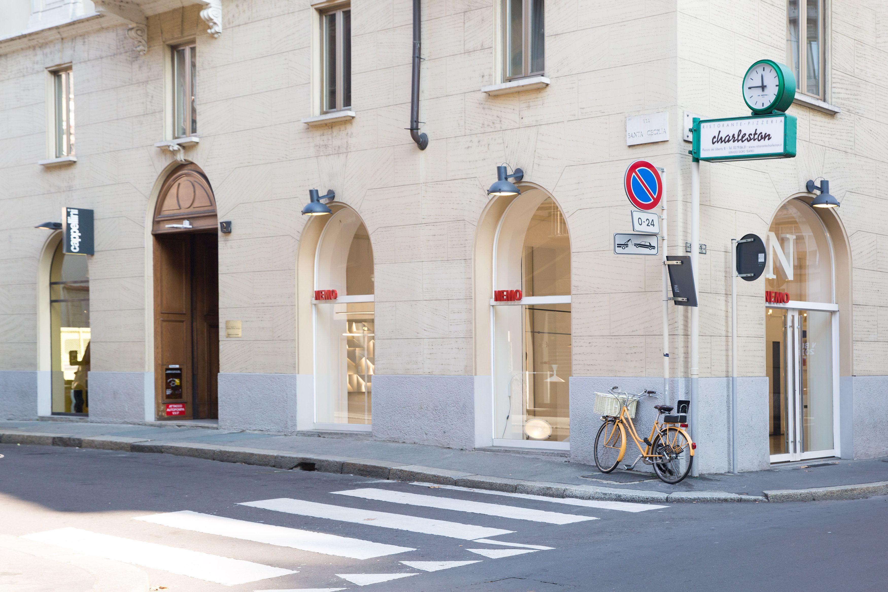 A building with arched windows and a bicycle parked outside.