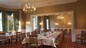 A formal dining room with a long table set for a meal, surrounded by wooden chairs. - Kaiserhof TWO by Centro Basic (Luebeck)