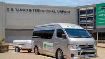 A Holiday Inn van parked in front of O.R. Tambo International Airport.