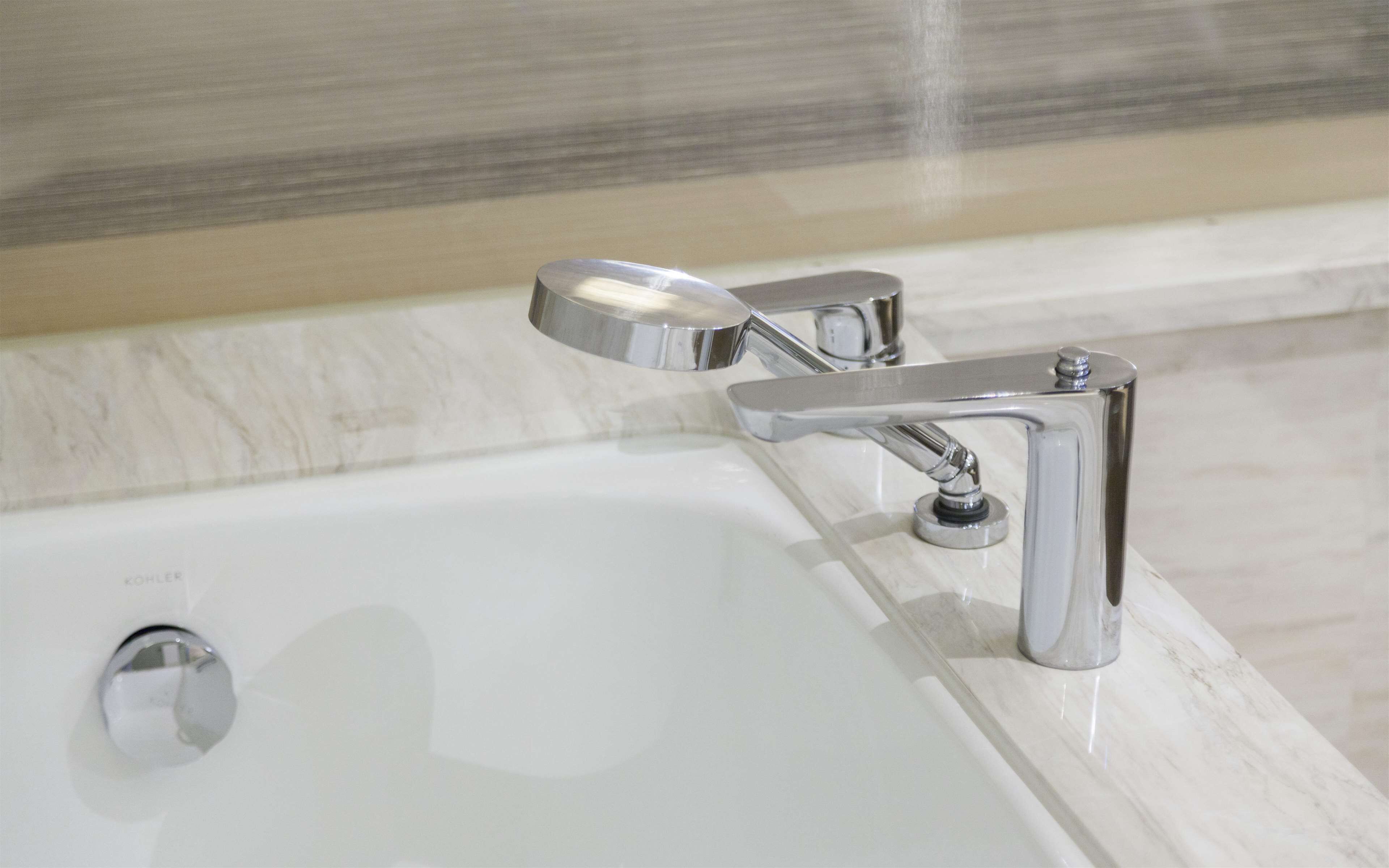 A modern bathroom with a chrome faucet and a single lever handle.
