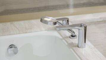 A modern bathroom with a chrome faucet and a single lever handle.