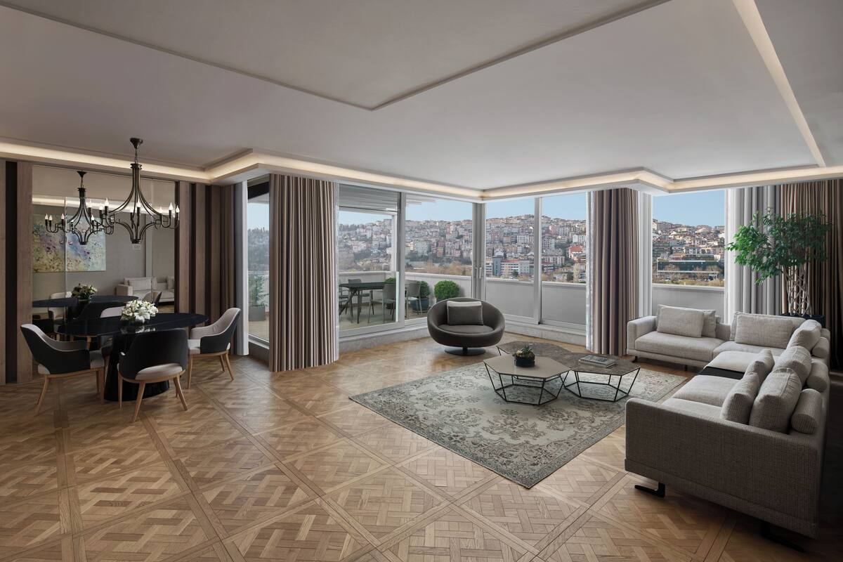 A spacious living room with a dining area, large windows, and a city view.