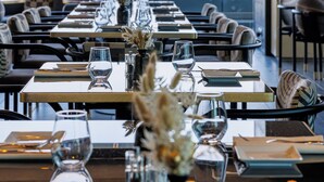 A restaurant with tables set for dining, a city view, and a 'RADIO' sign in the background. - ME Milan - Il Duca (Milan)