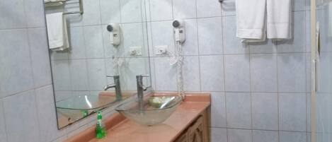 Une salle de bain avec des toilettes, un lavabo et un miroir.
