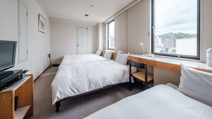 A hotel room with two beds, a desk, a TV, and a large window with a city view. - Tabist THE GREEN OTARU (Otaru)
