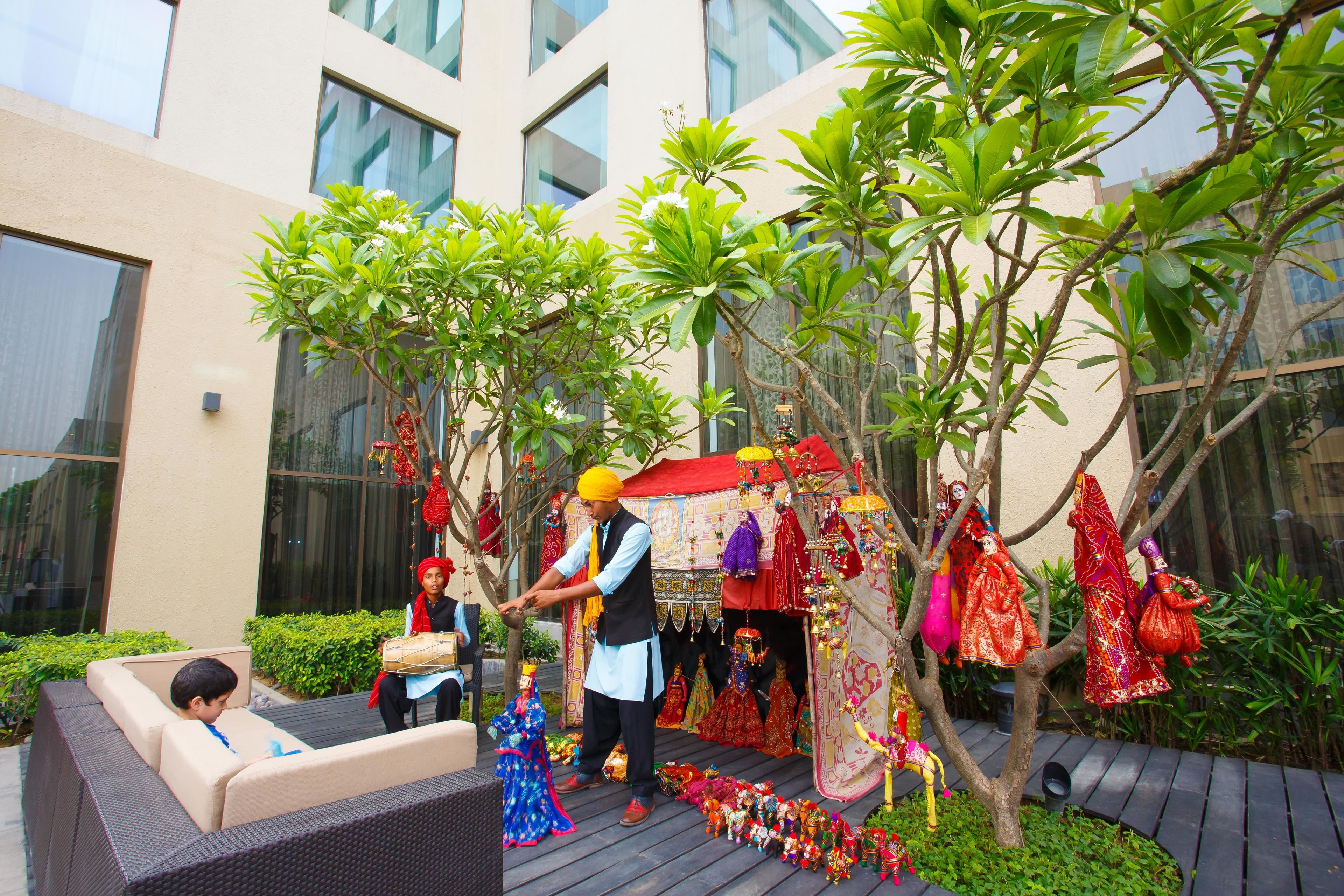 A courtyard with a stage, seating, and decorative elements.