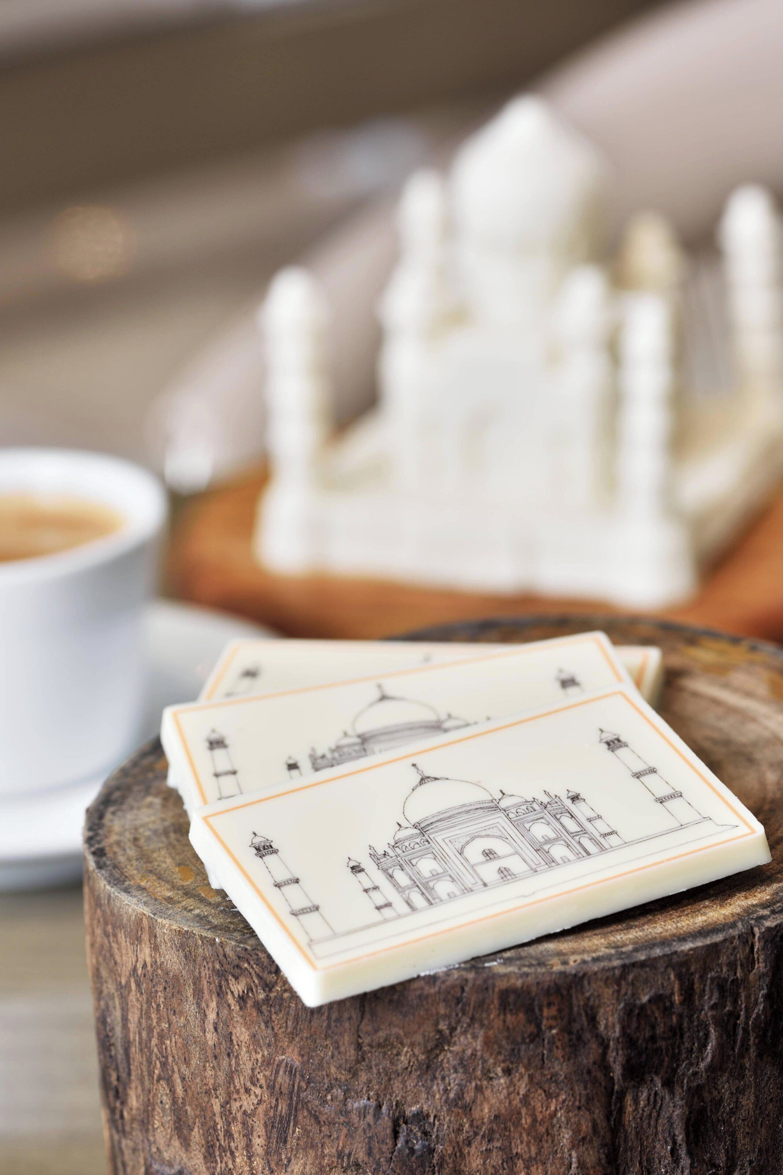 Playing cards with architectural designs on a wooden surface.