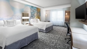 A hotel room with two beds, a desk, a TV, and a large abstract painting on the wall. - Courtyard Houston Katy Mills (Katy)