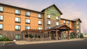 A multi-story hotel with a stone facade and a sign reading "Towneplace Suites by Marriott." - TownePlace Suites Billings (Billings)