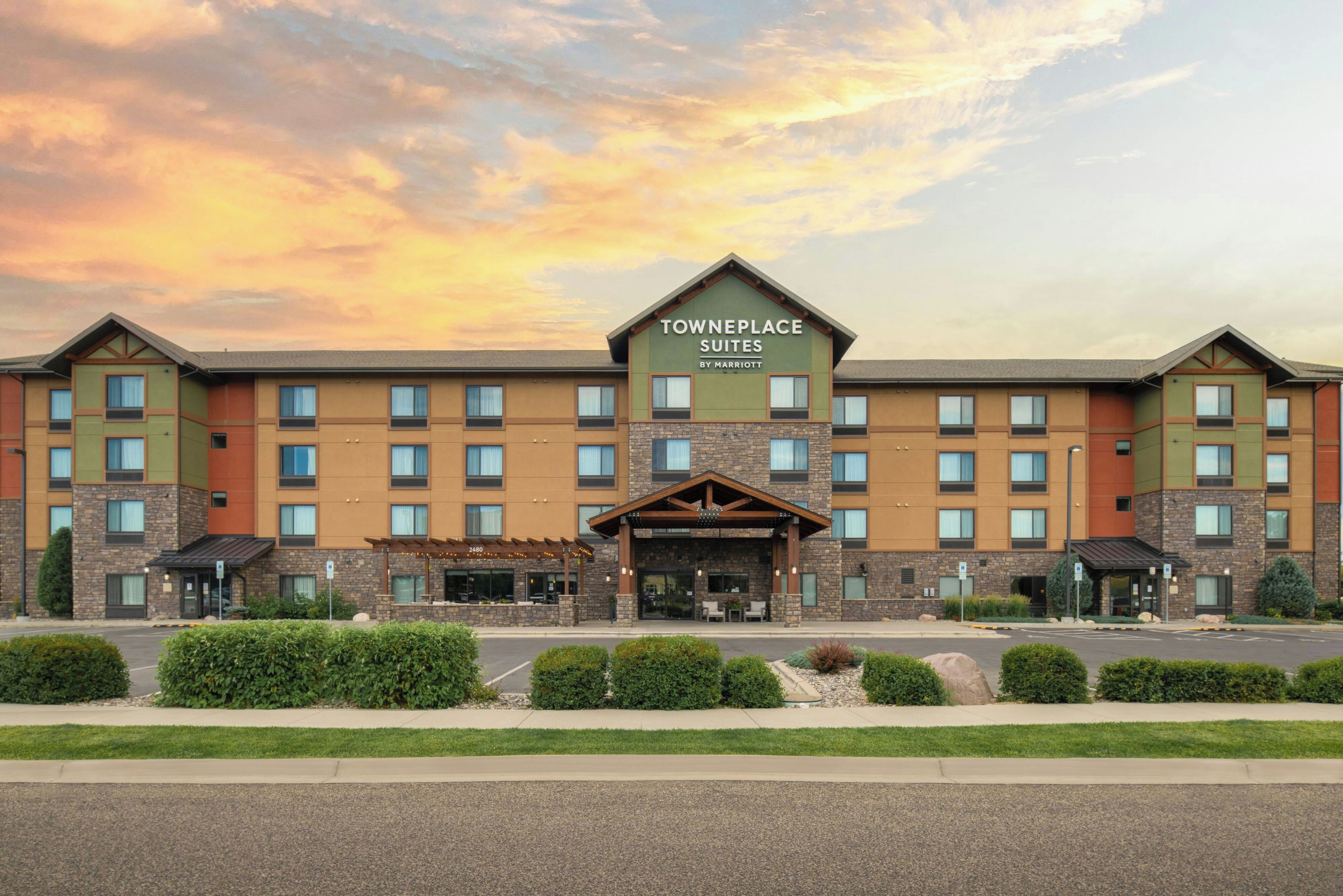 A TownePlace Suites hotel with a central entrance, multiple floors, and a parking lot.