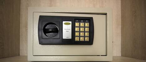A safe with a keypad and a card slot, labeled "SAFEGUARD" and "Electronic digit safe."