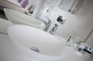 A modern bathroom with two white sinks and a mirror.