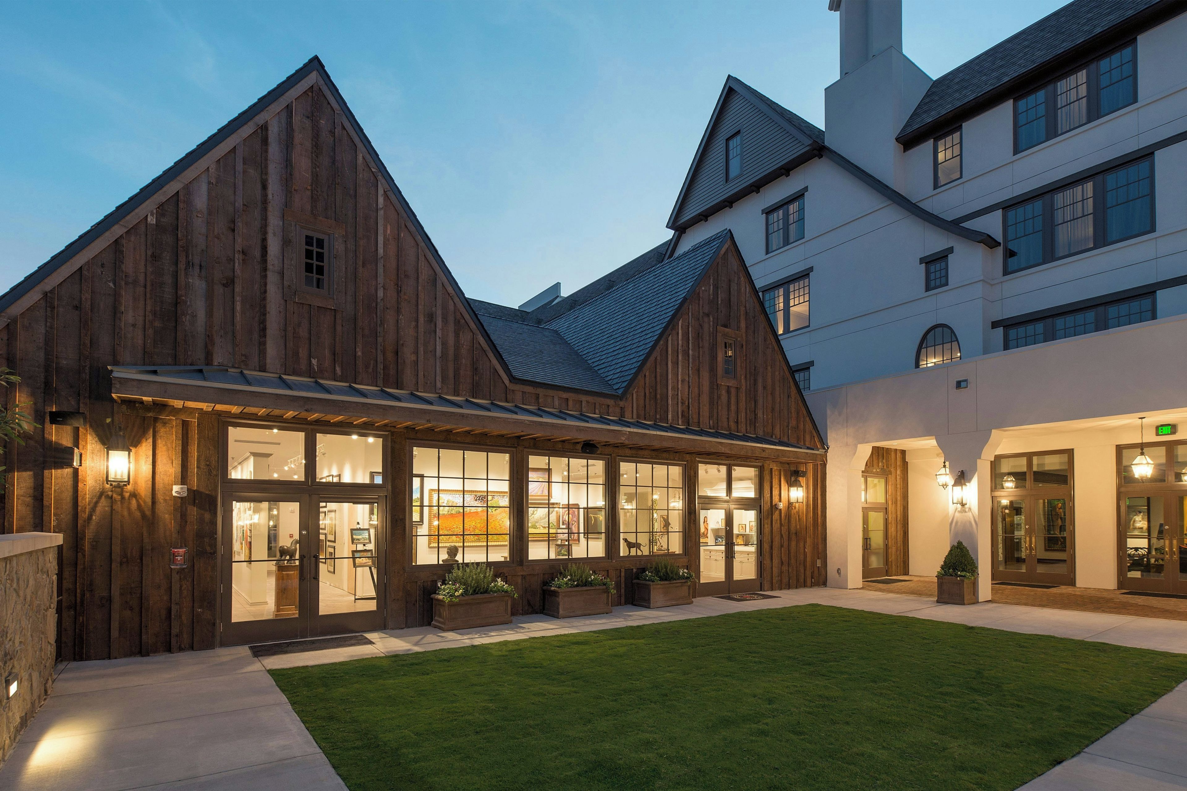 A building with a wooden facade and large windows, likely a hotel or guesthouse.