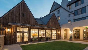 A building with a wooden facade and large windows, likely a hotel or guesthouse.