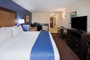 A hotel room with a large bed, a desk with a computer, a television, and a chair. - Holiday Inn Express & Suites Davenport by IHG (Davenport)