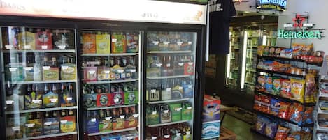 A convenience store with refrigerated sections for beverages and snacks.