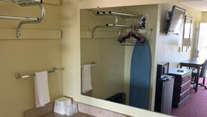 A bathroom with a granite countertop, a sink, a mirror, and a towel rack. - Western Motel - Prentiss (Prentiss)