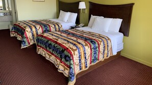 A hotel room with two beds, a large mirror, a framed picture on the wall, and a lamp on the nightstand. - Western Motel - Prentiss (Prentiss)