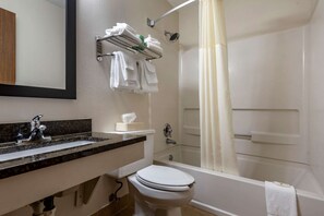 A bathroom with a sink, toilet, and bathtub.