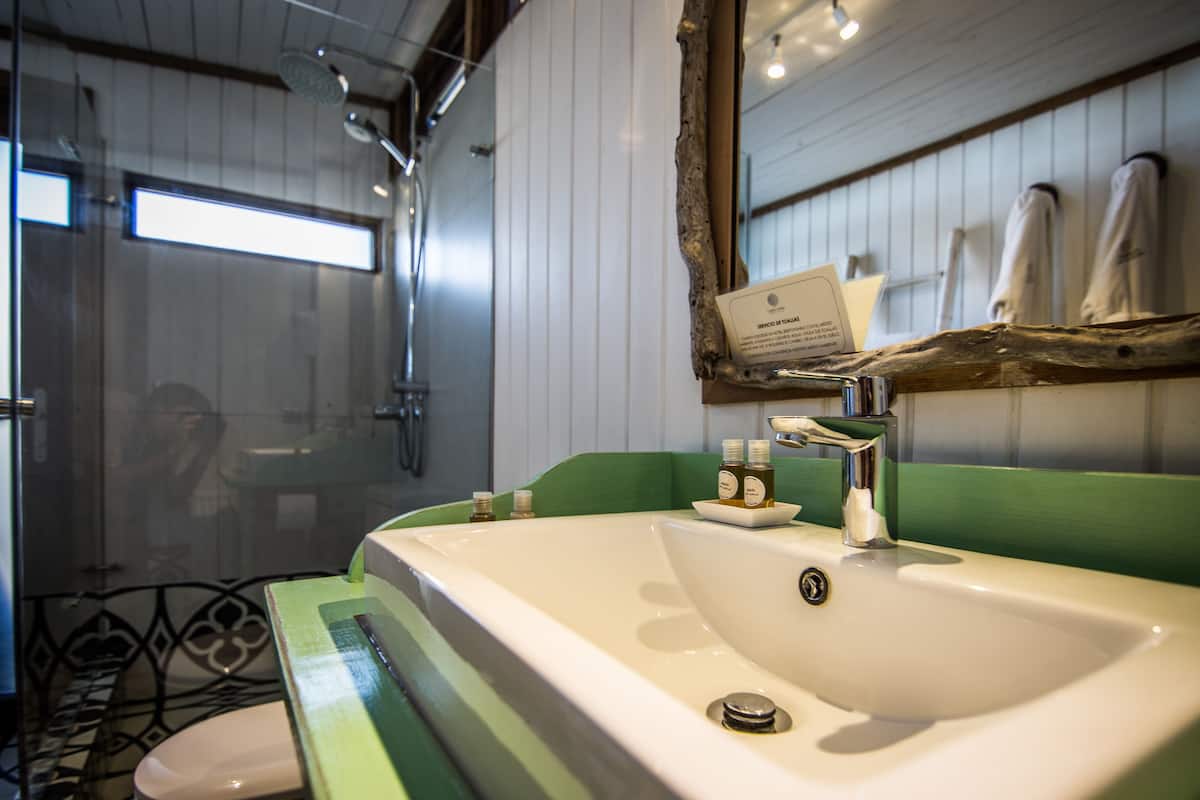 deluxe suite | bathroom | shower, hair dryer, bathrobes, towels