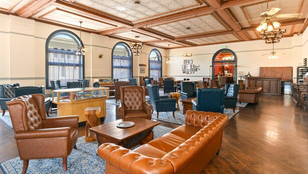 A spacious lobby with leather sofas, wooden tables, and a classic ceiling design. - Hotel St. Michael, BW Premier Collection (Prescott)