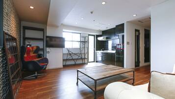 Deluxe Two Bedroom Apartment | Living area | Flat-screen TV