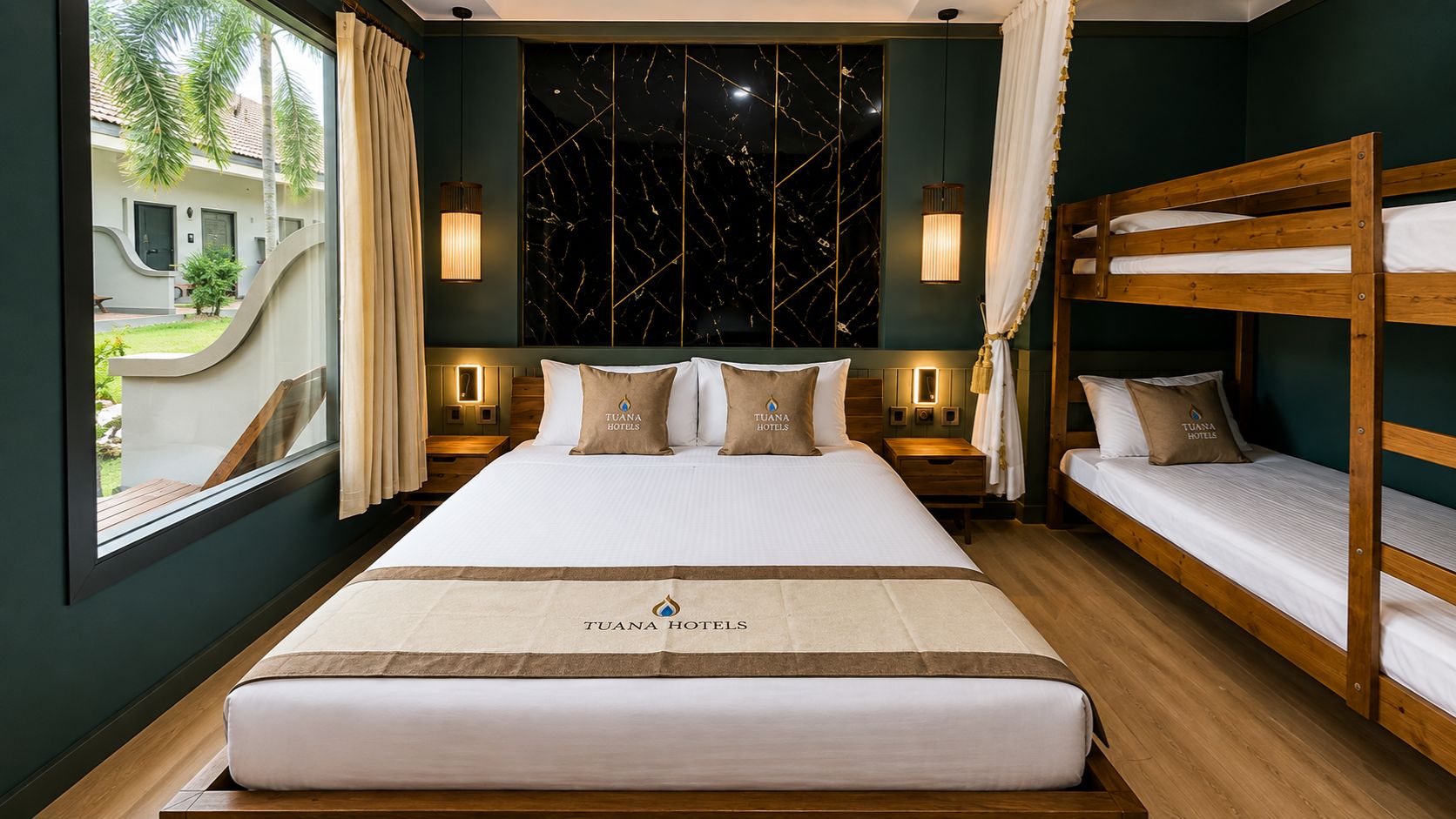 A hotel room with a large bed, a bunk bed, and a view of a building outside.