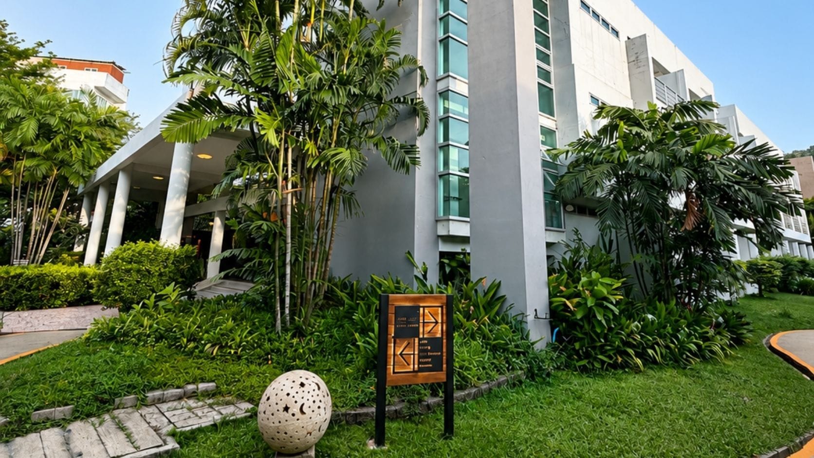 A modern building with a sign indicating a hotel or resort.
