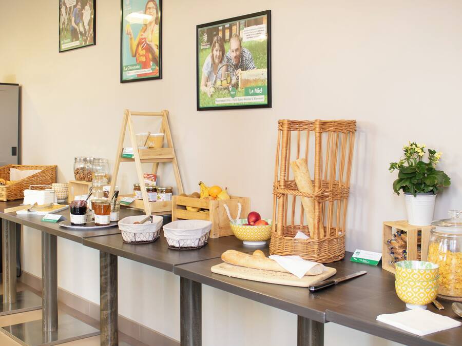 A buffet table with various food items, baskets, and a plant.