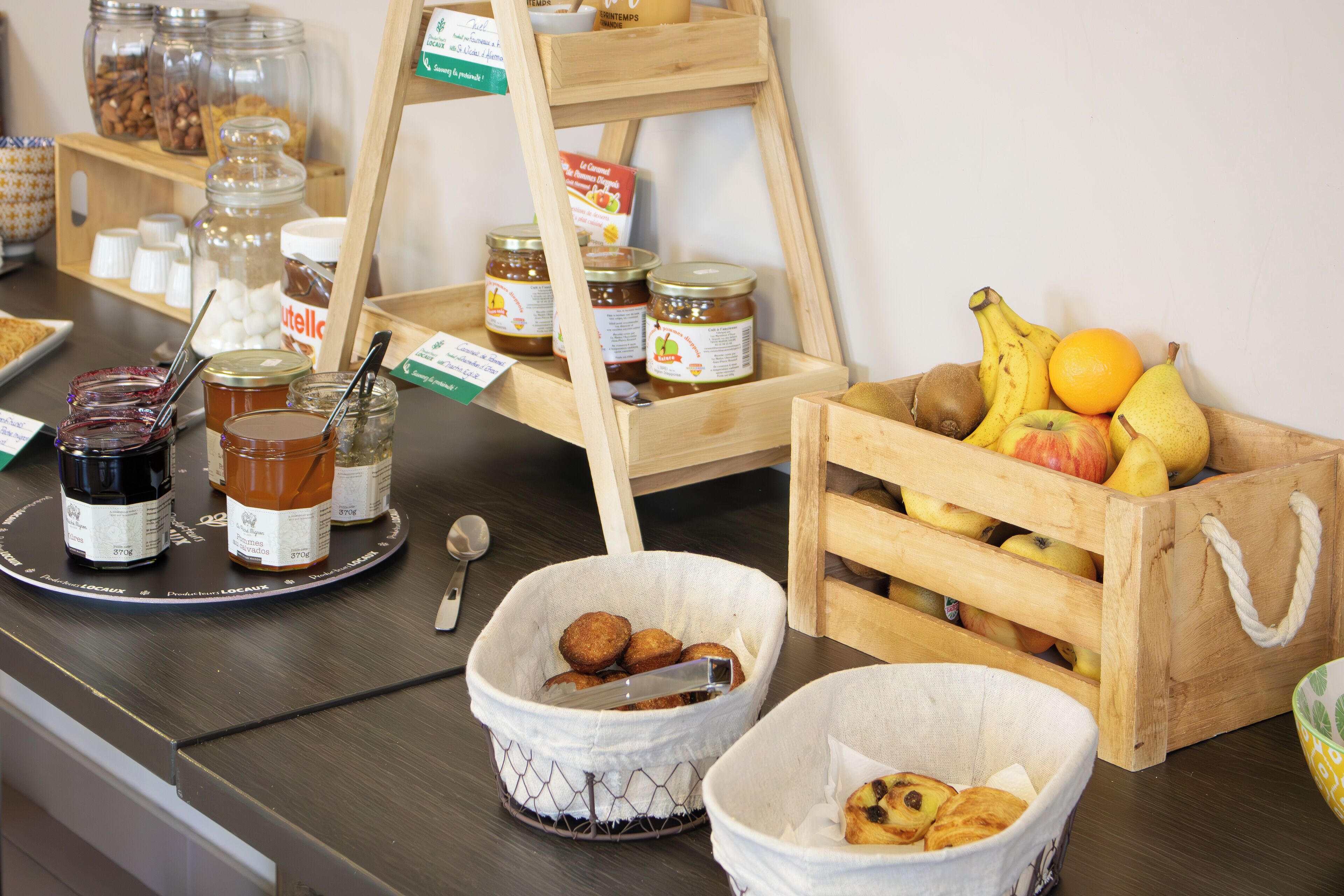A breakfast buffet with various food items and condiments.