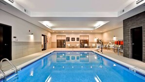 A swimming pool with a tiled edge, a ladder, and a few lounge chairs. - Homewood Suites by Hilton Cincinnati/West Chester (West Chester)