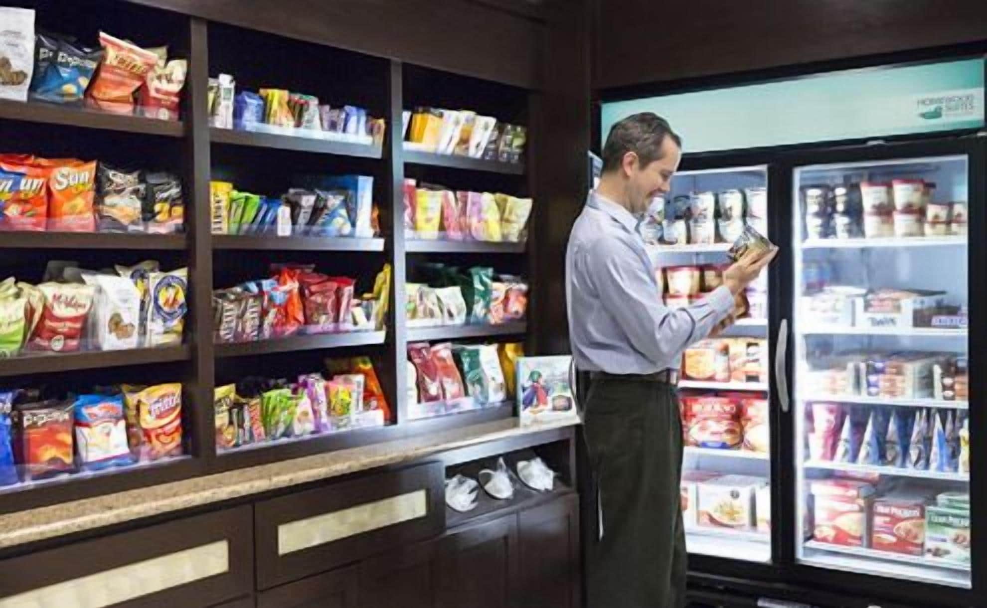A grocery store with shelves stocked with various snacks and packaged goods.