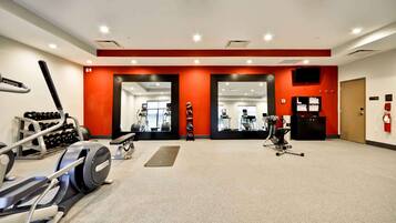 A gym with treadmills, weights, and exercise machines.