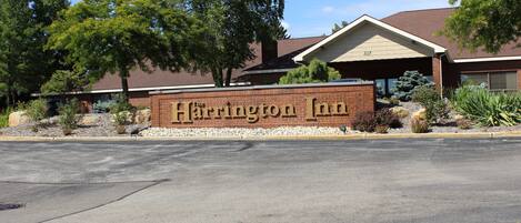 A brick building with a sign that reads "Harrington Inn".