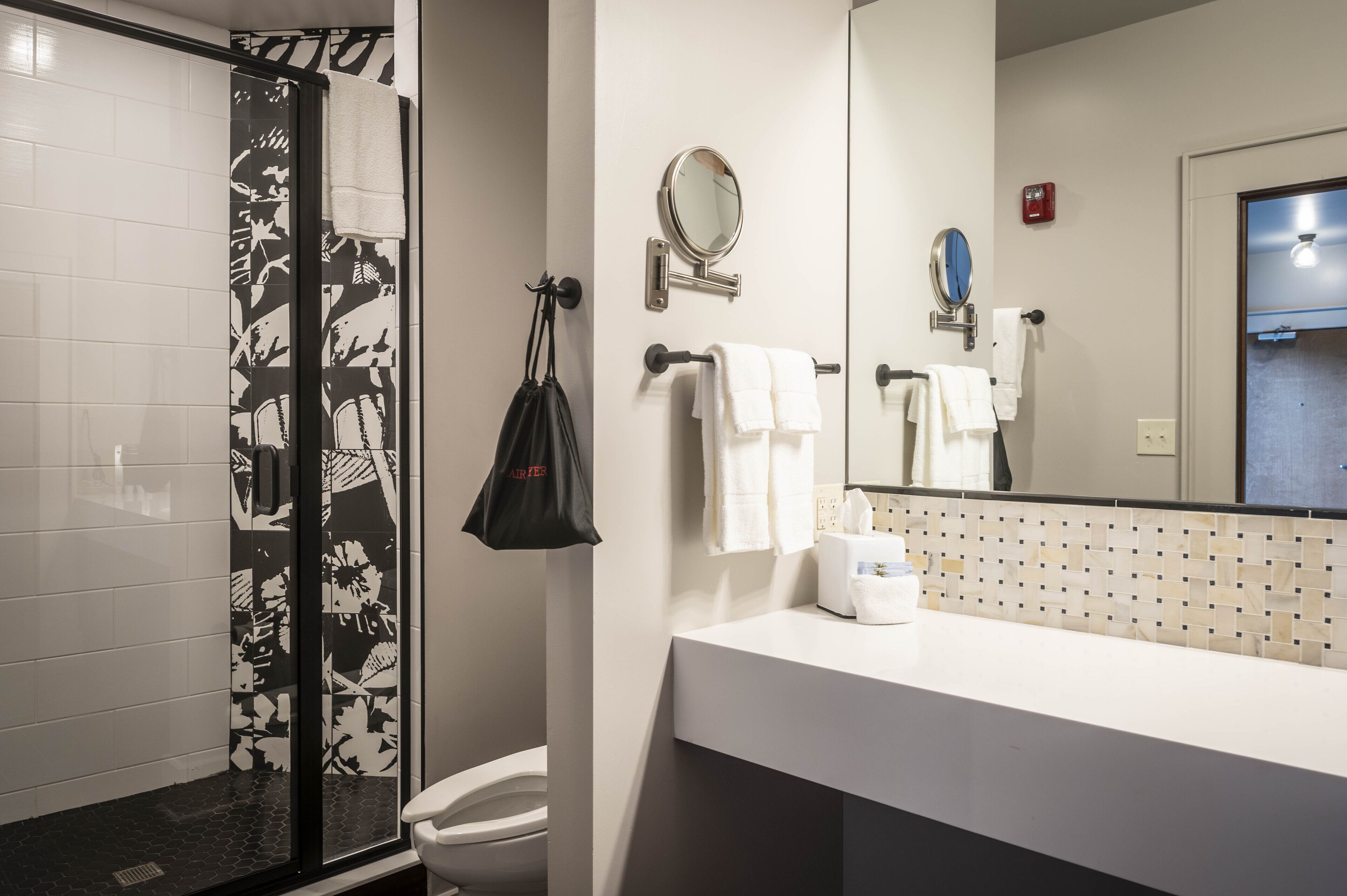 A bathroom with a shower, toilet, and sink.
