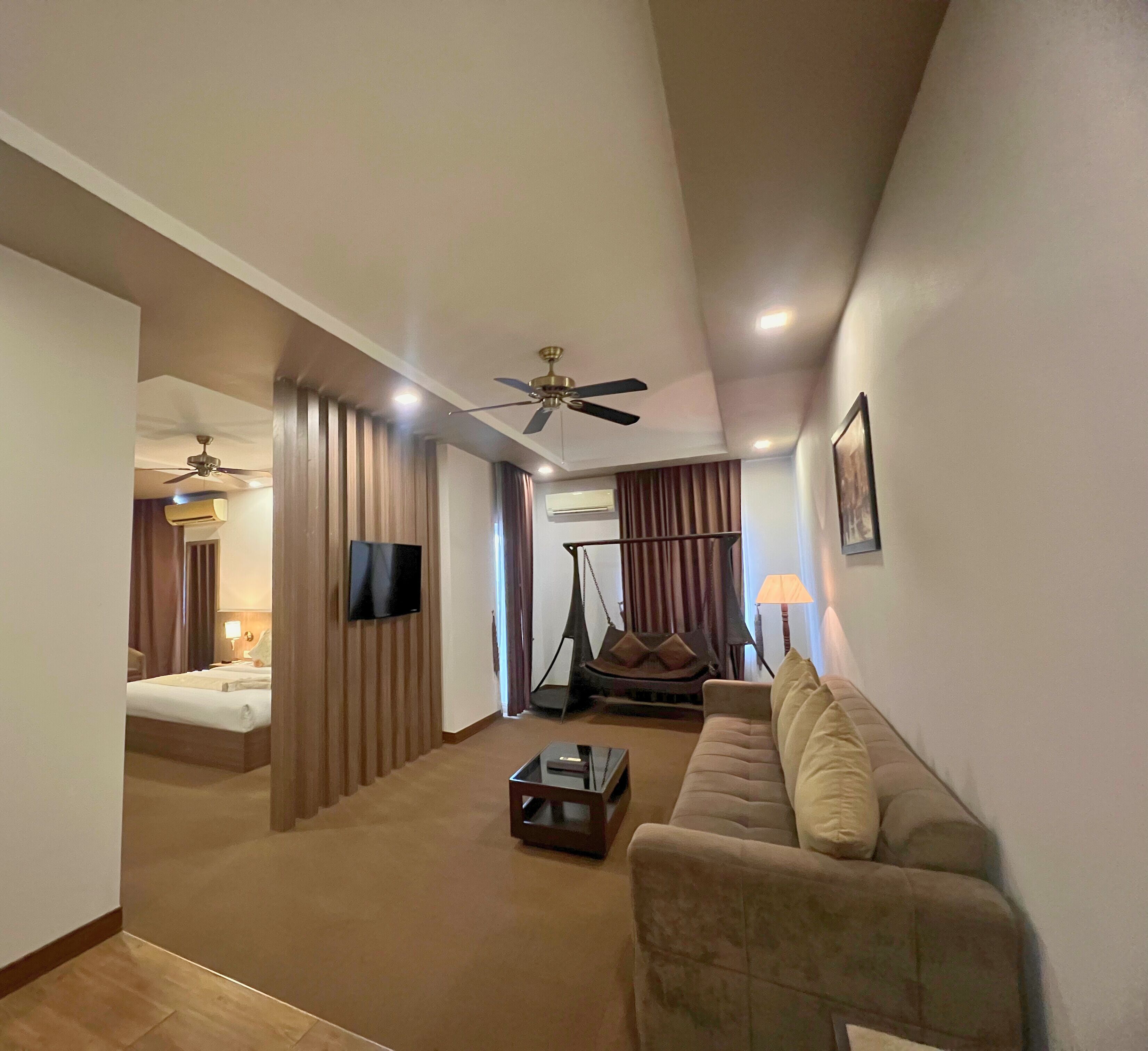 anik executive suite | living area | tv, fireplace, books