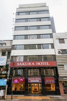 A multi-story building with a prominent "SAKURA HOTEL" sign.