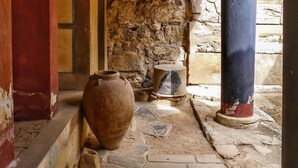 A stone-walled corridor with a large pot and a pillar. - Archontiko (Malevizi)