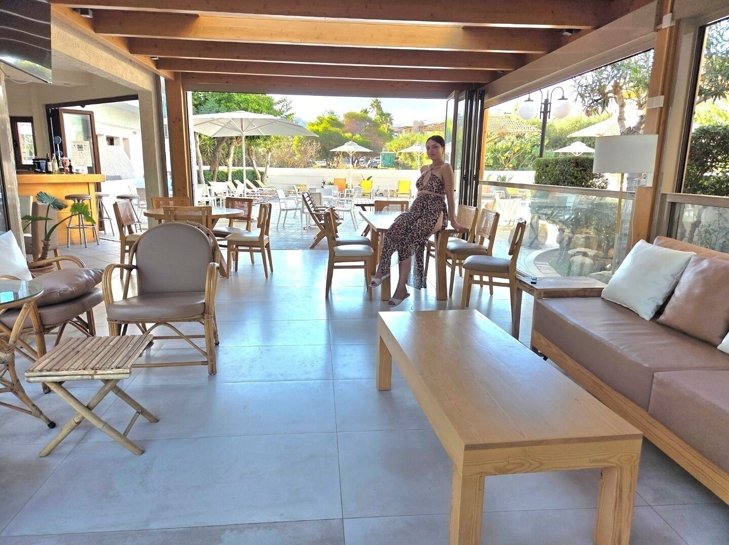A spacious indoor area with wooden furniture, a sofa, and a table.
